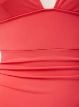 Close up and detailed short of coral red 78% Recycled Repreve® Nylon 22% Spandex fabric