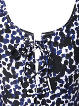 close up shot of a black and white leopard print classic tank silhouette one piece swimsuit with lace-up front 