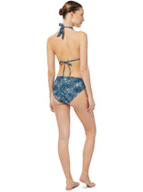 Model wears bikini top and mid rise bikini bottom with teal and white abstract wave print 