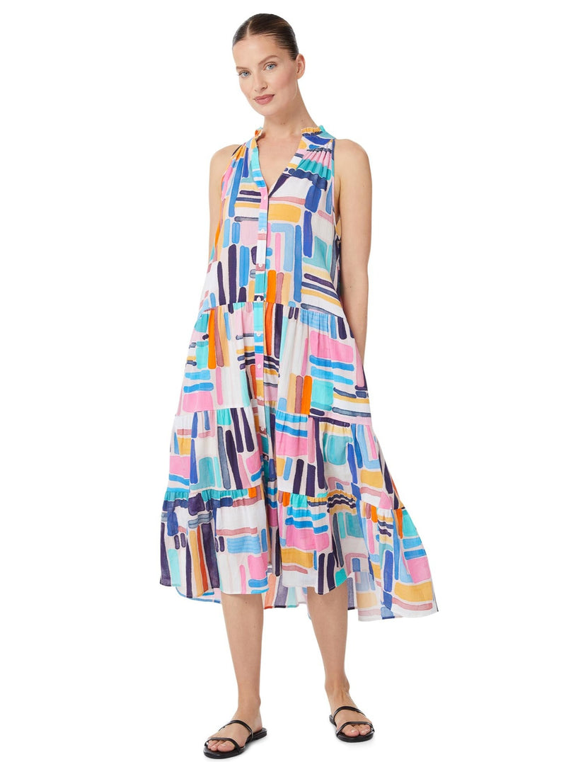 Model smiling and wearing a geometric and graphic colored sleeveless, high neck with ruffle detail, buttoned shirt dress with optional matching belt with tassels and pockets.. 