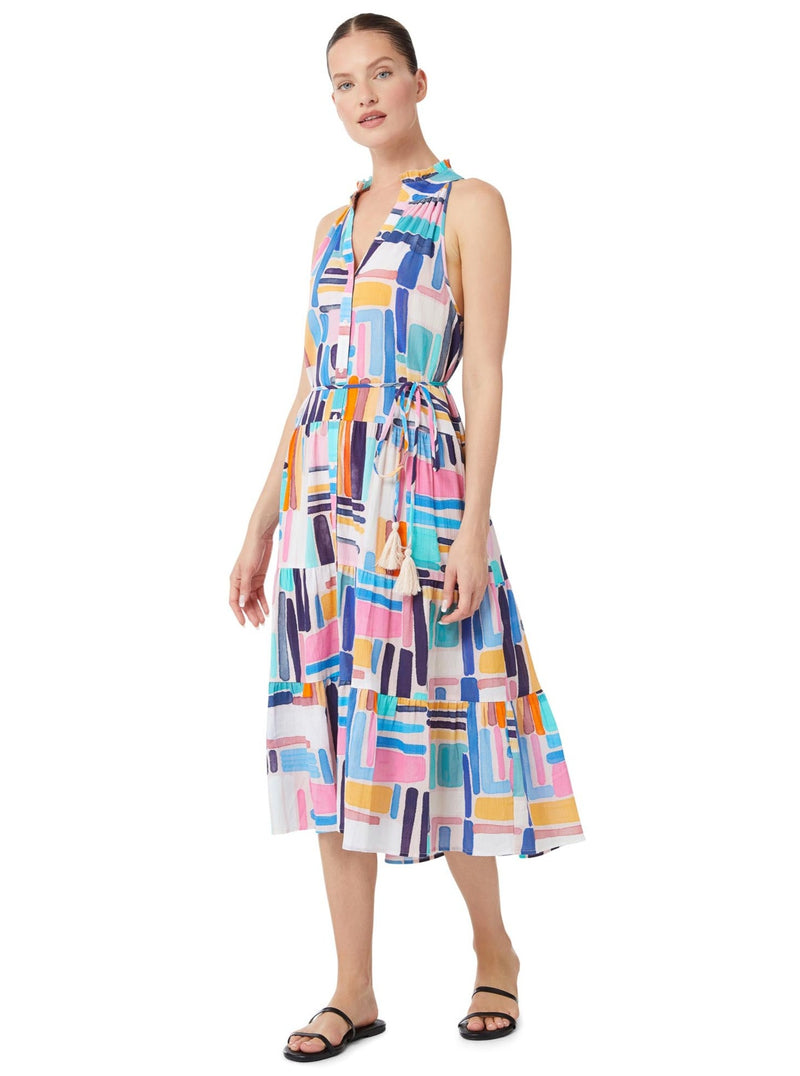 Model looking forward and wearing a geometric and graphic colored sleeveless, high neck with ruffle detail, buttoned shirt dress with optional matching belt with tassels and pockets.. 