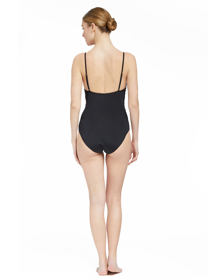 the back of Model wearing black v-neckline one piece bathing suit with adjustable back straps 